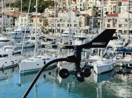 Lustica, Montenegro - 01 november 2023. Modern anemometer with a weathervane near the marina near the resort town photo