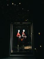 Tivat, Montenegro - 25 december 2022. Darkened shop window with classic women clothing photo