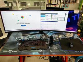 Budva, Montenegro - 25 december 2022. Large concave monitor stands in front of a keyboard on a table in an electronics store photo