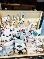 Kotor, Montenegro - 25 december 2022. Souvenir pillows in the form of cats, rabbits and dogs stand on a store shelf photo