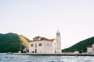 Church of Our Lady on the Rocks on an island in the Bay of Kotor with mountains in the background. Montenegro photo