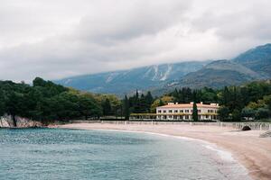 Clean deserted beach near Villa Milocer at the foot of the mountains. Montenegro photo