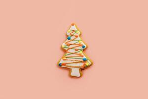 Glazed Christmas tree cookie on a beige background photo