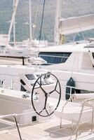 White leather seat with backrest at the helm of a yacht moored in the port photo