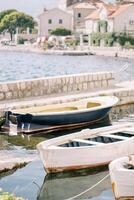 vistoso de madera pescar barcos son amarrado cerca el perast muelle. montenegro foto