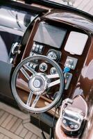 Steering wheel and control panel of a modern motor yacht. Top view photo