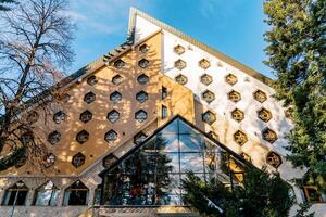 Triangular Bianca Resort and Spa hotel with honeycomb windows in the forest. Kolasin, Montenegro photo