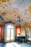 Colorful painted ceiling with stucco and chandelier of a luxurious ancient villa. Lake Como, Italy photo