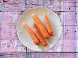 Carrots On The Wooden Background photo