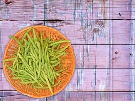 Vegetales de judías verdes sobre fondo de madera foto