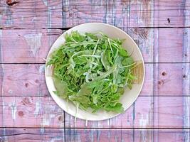 Arugula On Wooden Background photo