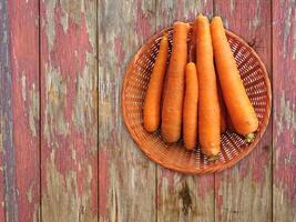 Carrots On The Wooden Background photo