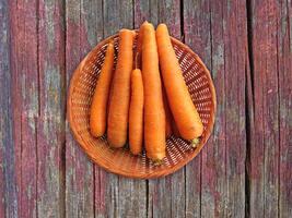 Carrots On The Wooden Background photo