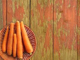 Carrots On The Wooden Background photo