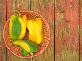 Peppers On The Wooden Background photo