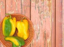 Peppers On The Wooden Background photo