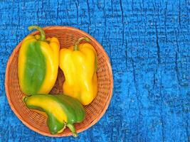 Peppers On The Wooden Background photo