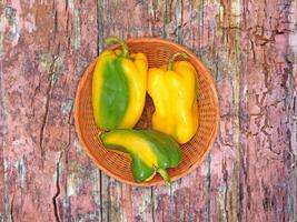 Peppers On The Wooden Background photo