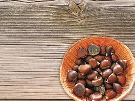 Chestnuts On The Wooden Background photo