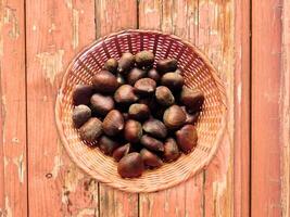 Chestnuts On The Wooden Background photo