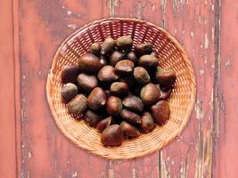 Chestnuts On The Wooden Background photo