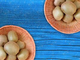 Kiwi On Wooden Background photo