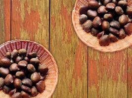 Chestnuts On The Wooden Background photo