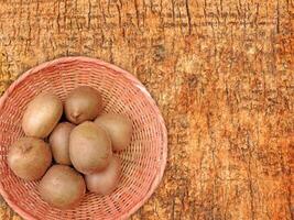 Kiwi On Wooden Background photo