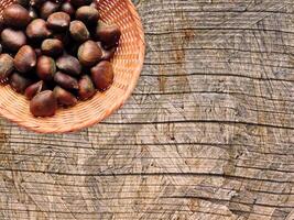 Chestnuts On The Wooden Background photo