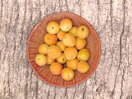 Apricots On The Wooden Background photo