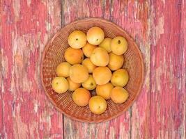 Apricots On The Wooden Background photo