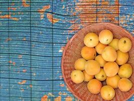 Apricots On The Wooden Background photo