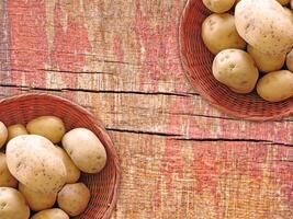 Potatoes On The Wooden Background photo