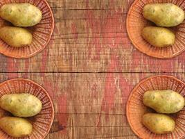 Potatoes On The Wooden Background photo