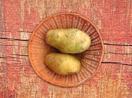 Potatoes On The Wooden Background photo