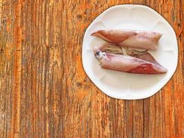 Squid On Wooden Background photo