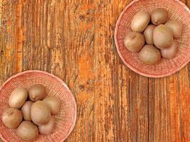 Kiwi On Wooden Background photo