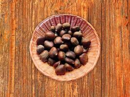 Chestnuts On The Wooden Background photo