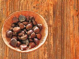 Chestnuts On The Wooden Background photo