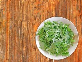 Arugula On Wooden Background photo