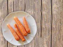 Carrots On The Wooden Background photo