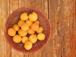 Apricots On The Wooden Background photo