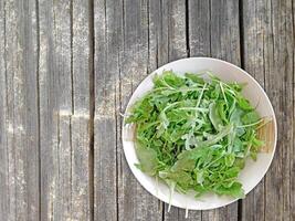 Arugula On Wooden Background photo