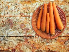 Carrots On The Wooden Background photo