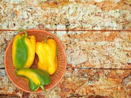 Peppers On The Wooden Background photo