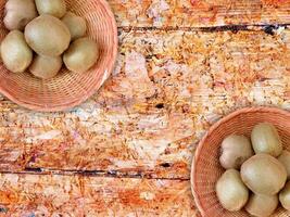 Kiwi On Wooden Background photo