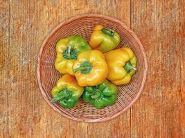 Peppers On The Wooden Background photo