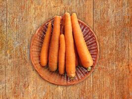 Carrots On The Wooden Background photo