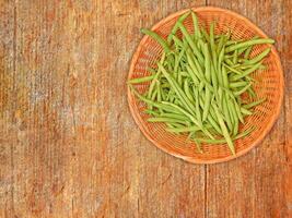 Green Bean Vegetable On Wooden Background photo