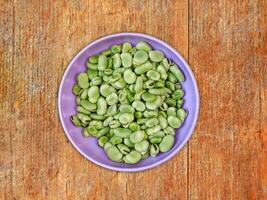 Broad Beans On Wooden Background photo